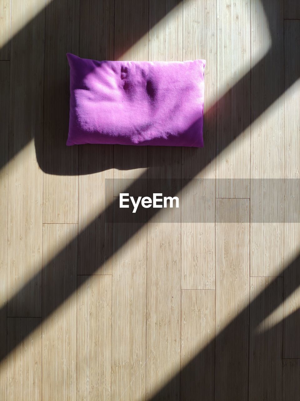 Purple cushion on hardwood floor