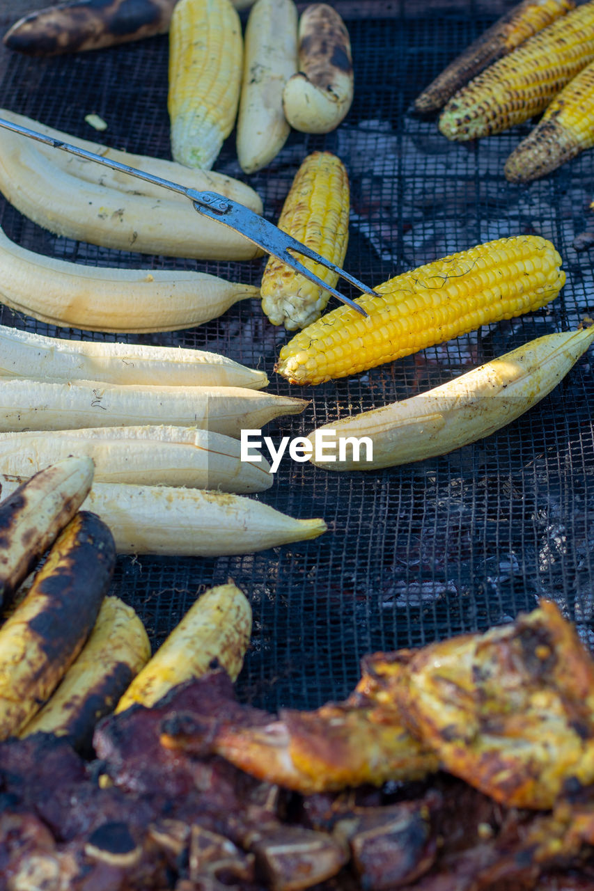 High angle view of meat and vegetables on barbecue grill