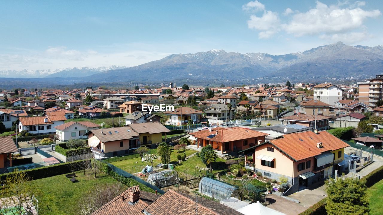 high angle view of townscape by sea against sky