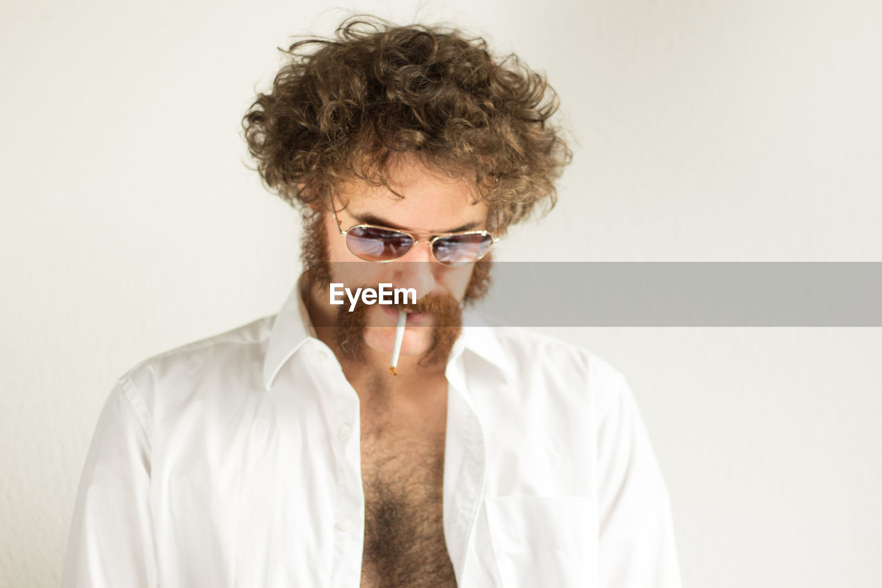 Man smoking cigarette against white background