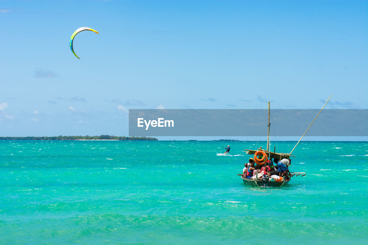 Group of people on a boat against sky