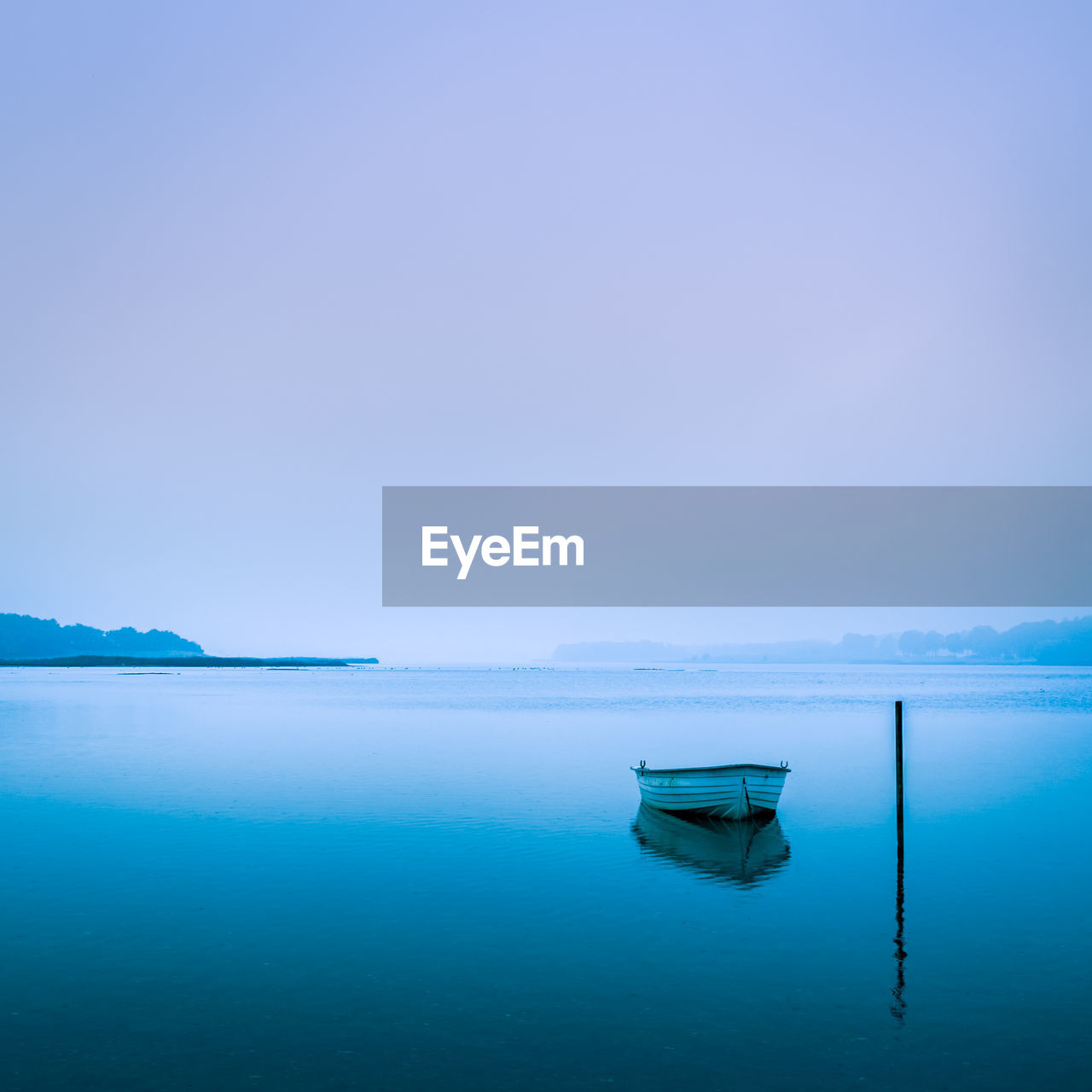 Boat on lake against clear sky