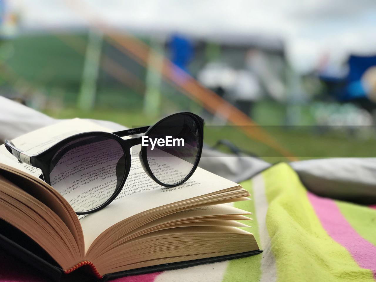 Close-up of sunglasses and book on table