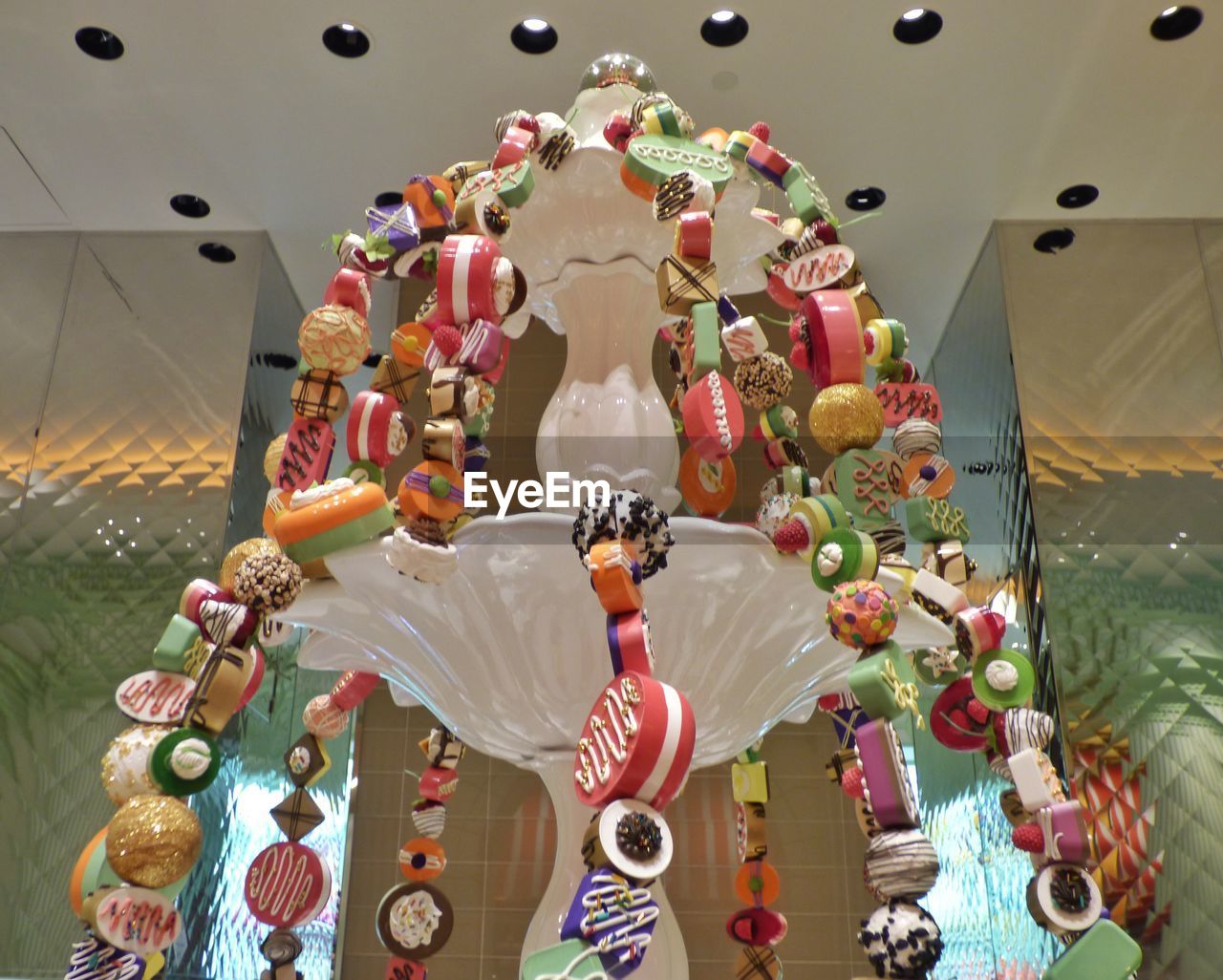 Low angle view of various desserts hanging on fountain at restaurant