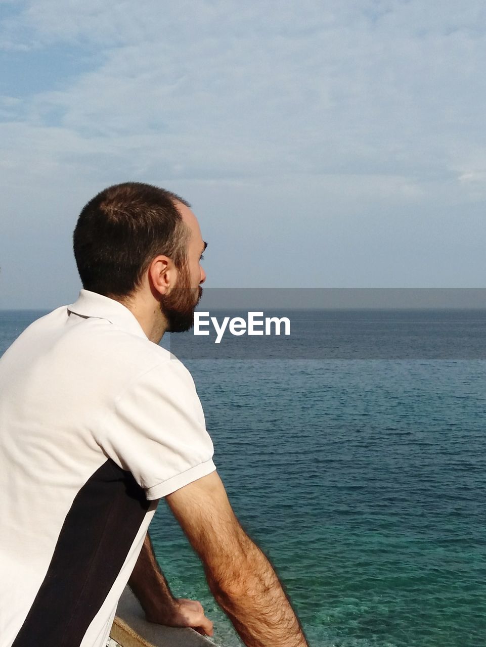 Man looking at sea against sky