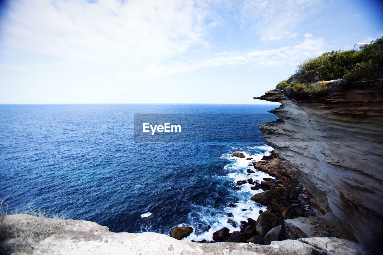 Scenic view of sea against cloudy sky