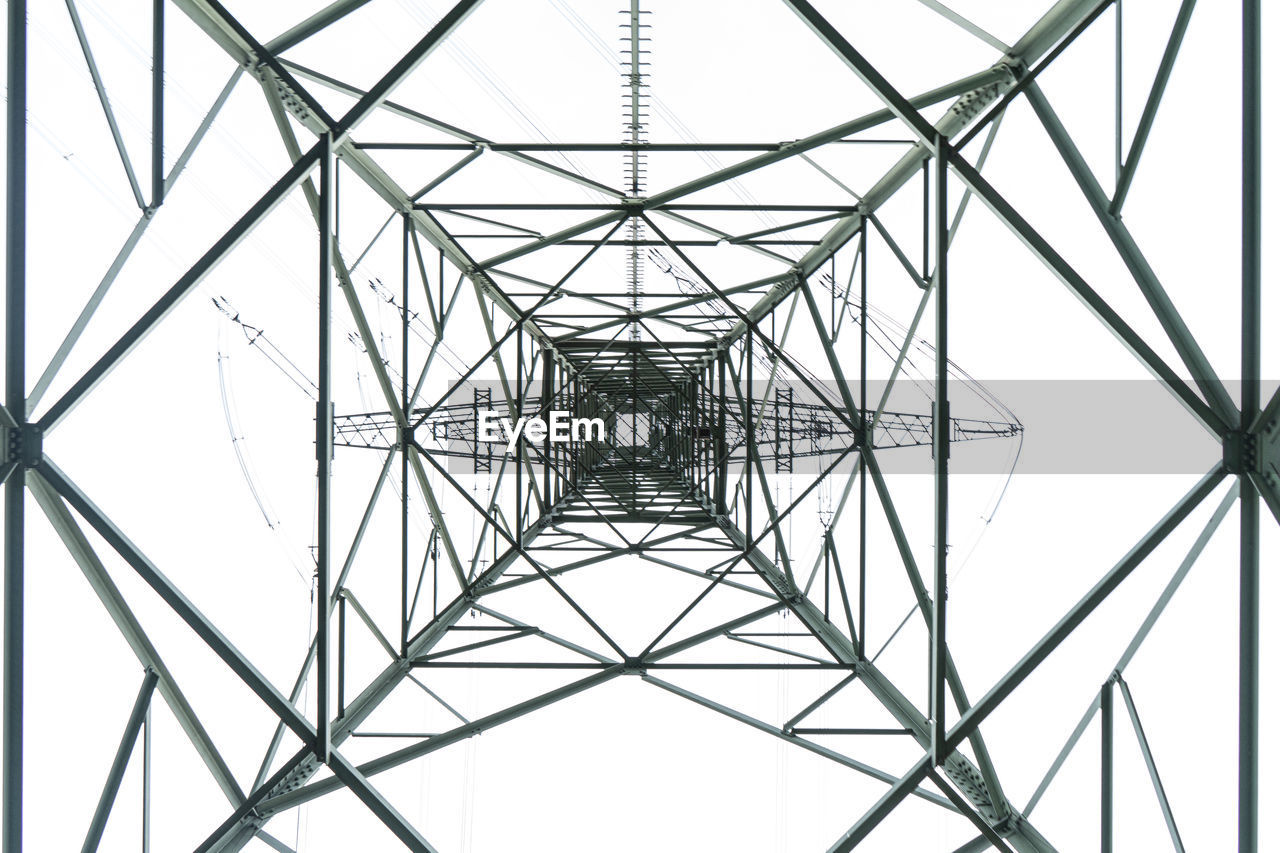 Low angle view of electricity pylon against clear sky