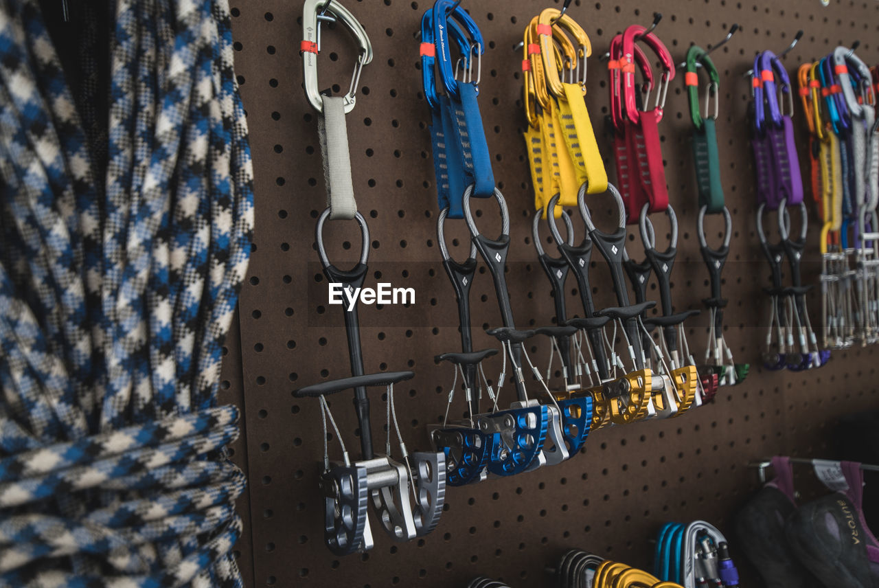 Close-up of multi colored safety harness hanging in store for sale