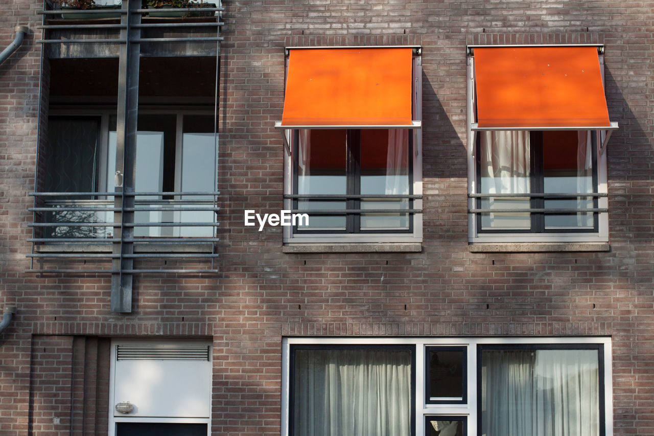 Closed glass windows and awnings on building