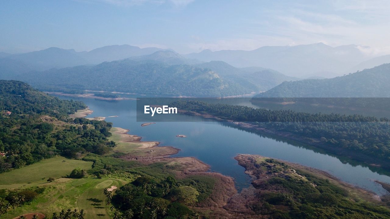 High angle view of lake and mountains against sky