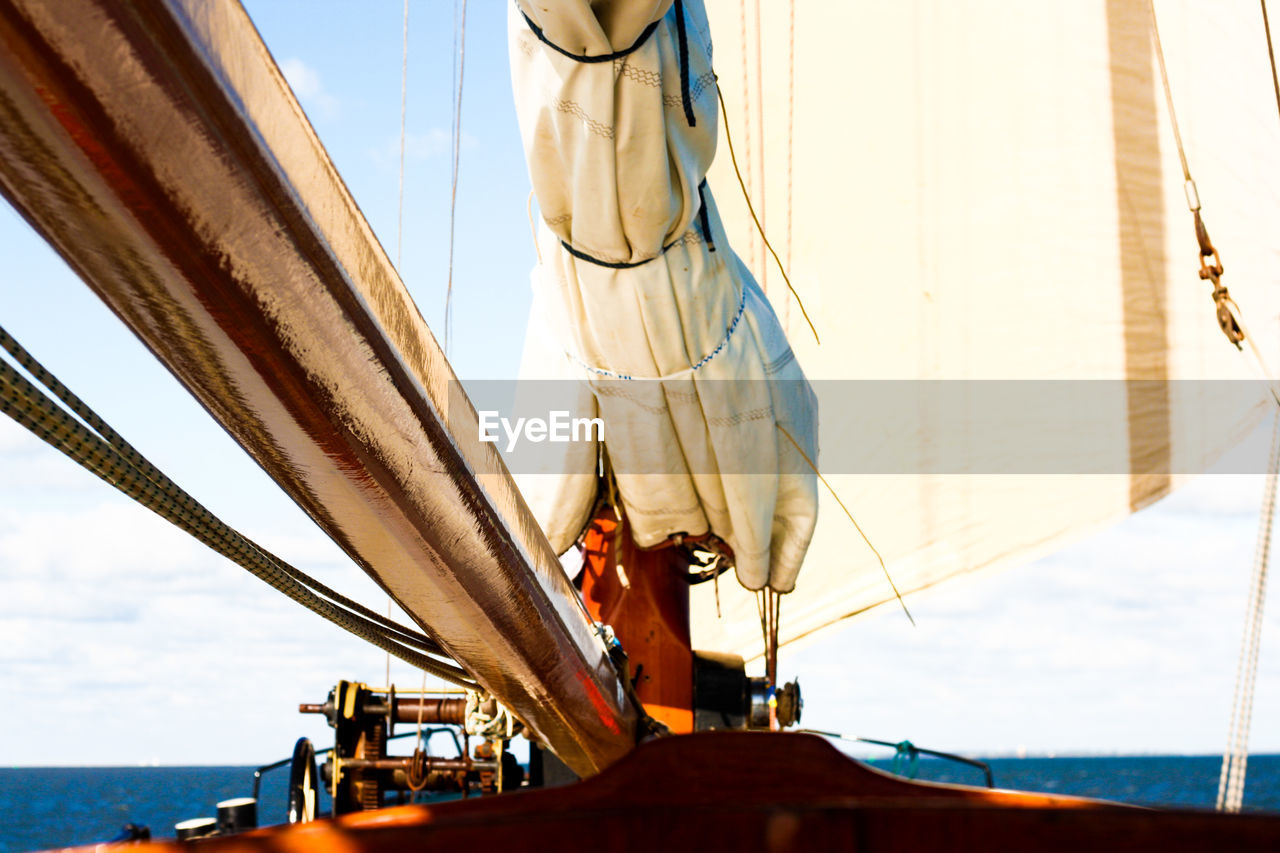 Sailboat sailing on sea against sky