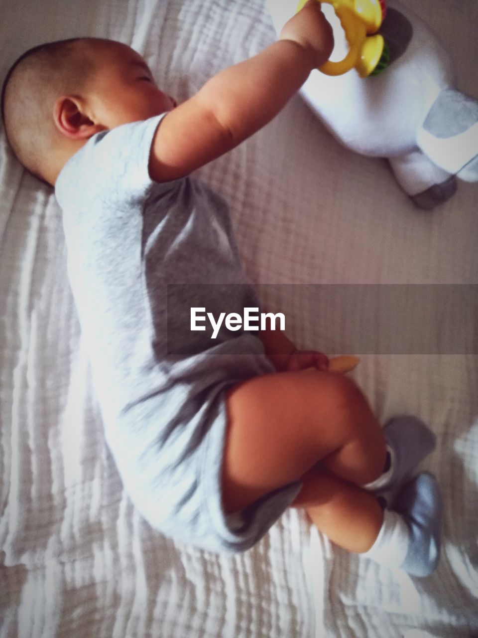 High angle view of toddler sleeping on bed at home