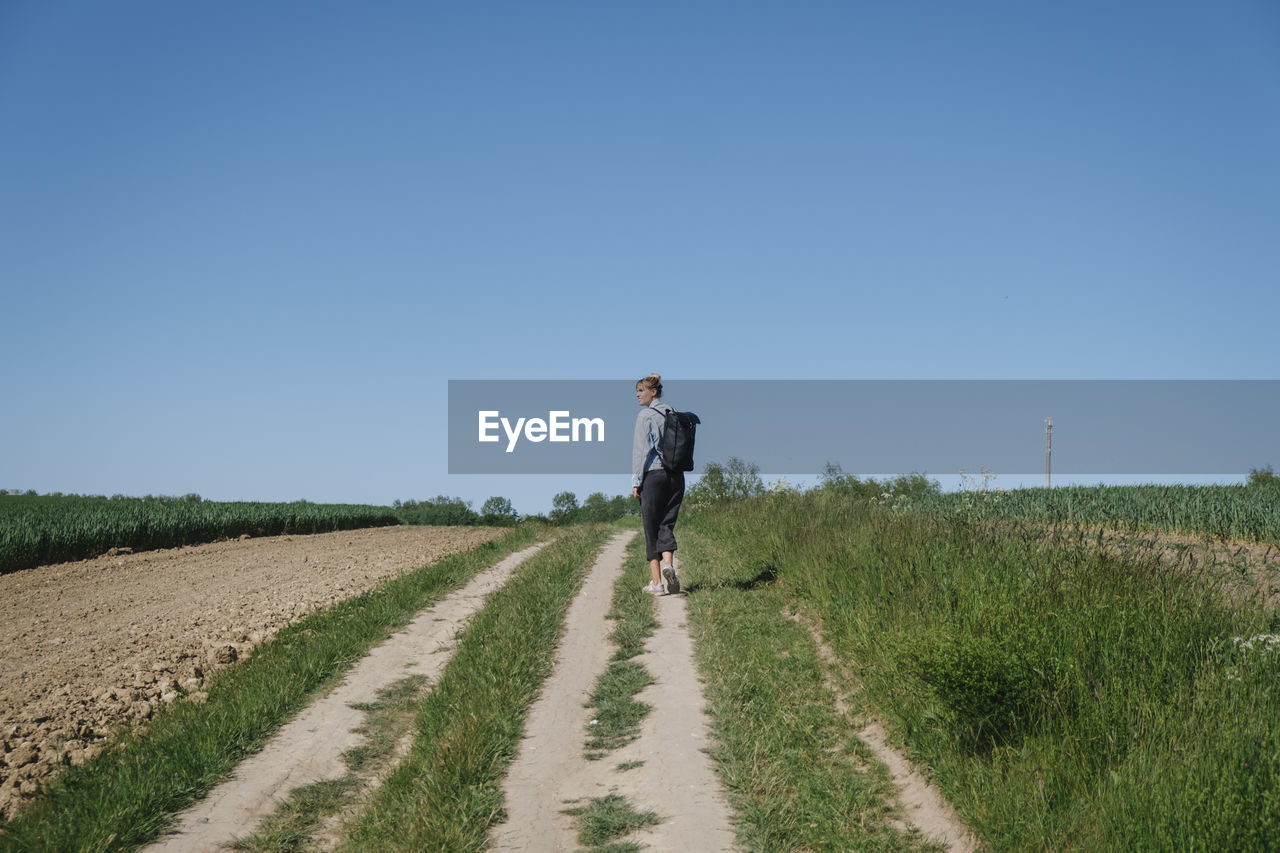 Full length of man on field against clear sky