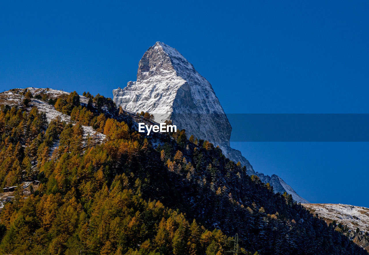 Low angle view of mountain against clear blue sky - matterhorn