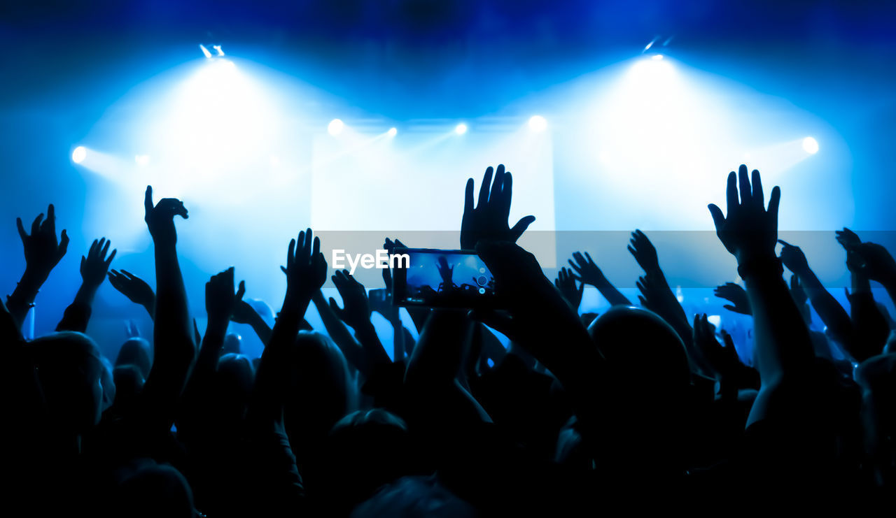 Crowd of people dancing at concert