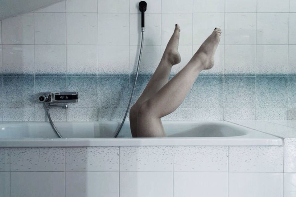 domestic bathroom, bathroom, domestic room, bathtub, taking a bath, human body part, water, one person, hygiene, wet, human leg, tile, one woman only, indoors, adults only, low section, only women, beauty, body care, relaxation, washing, shower, adult, women, people, one young woman only, young adult, day
