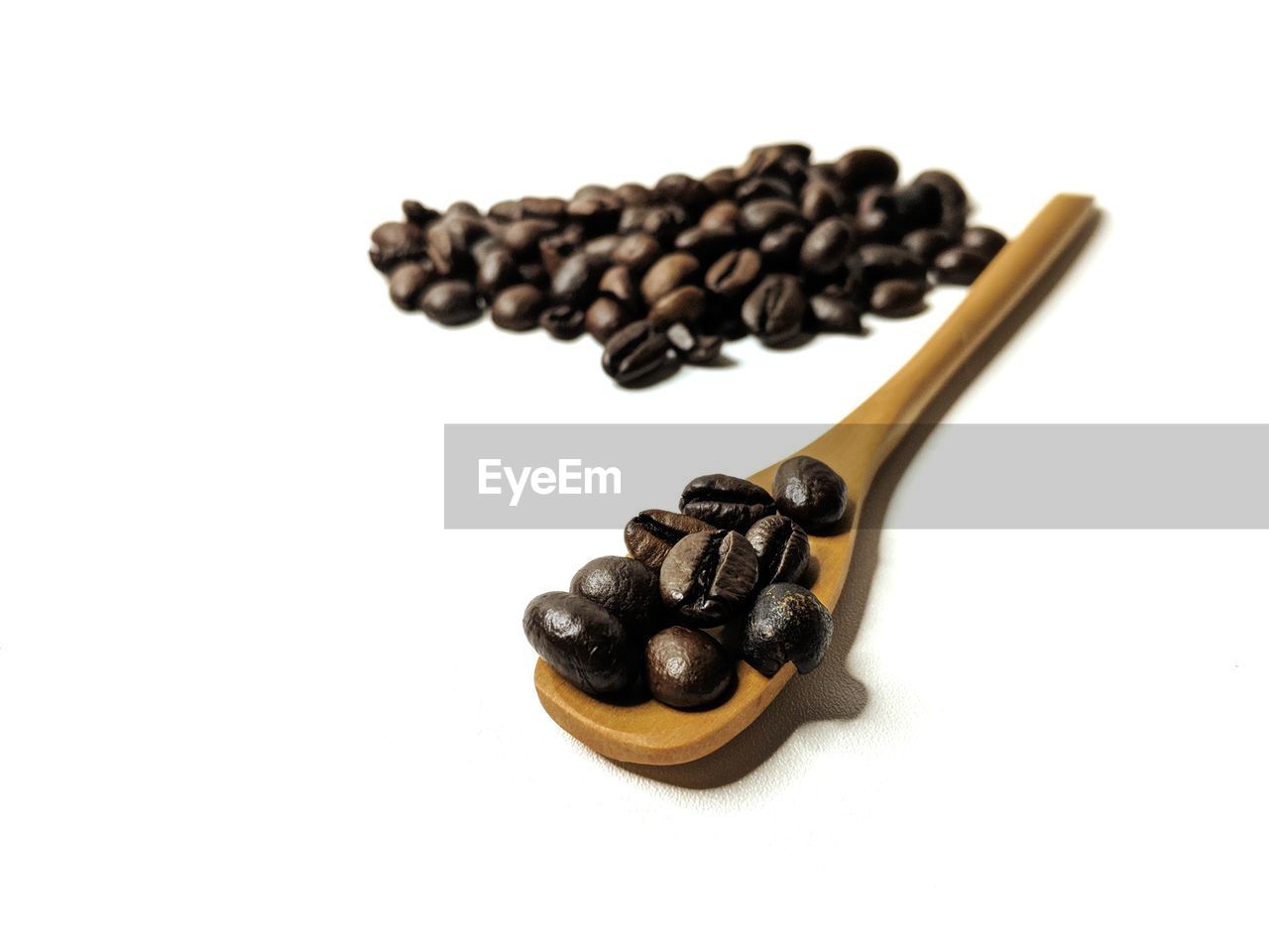 HIGH ANGLE VIEW OF COFFEE BEANS ON WHITE