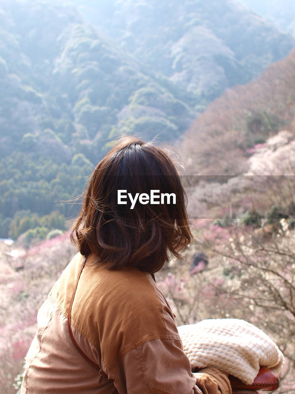 Rear view of woman looking at mountain range