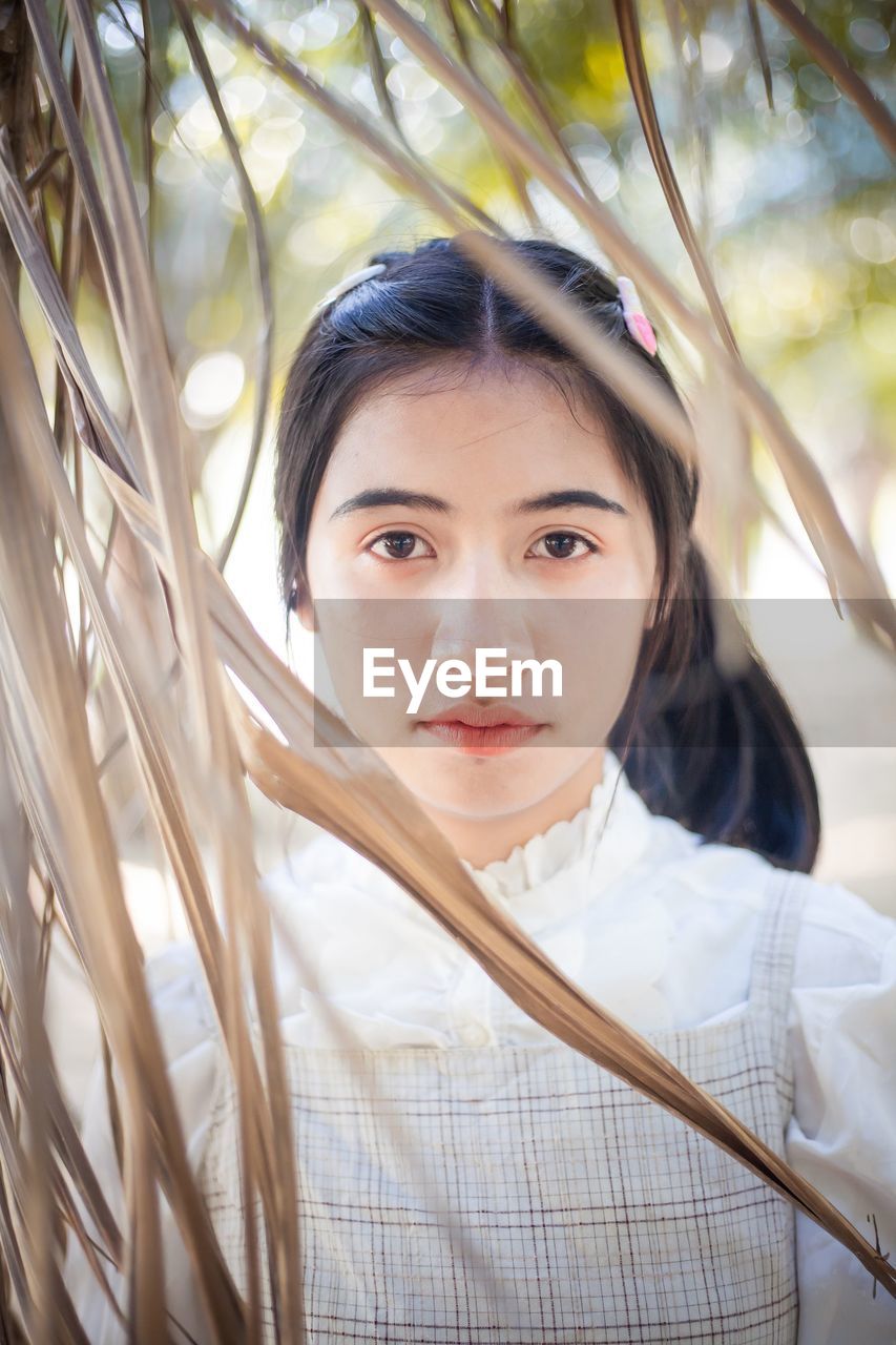 Portrait of woman by plants