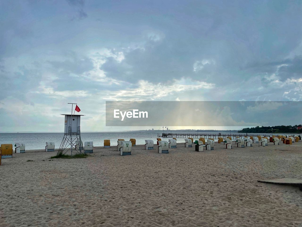 PEOPLE ON BEACH AGAINST SKY