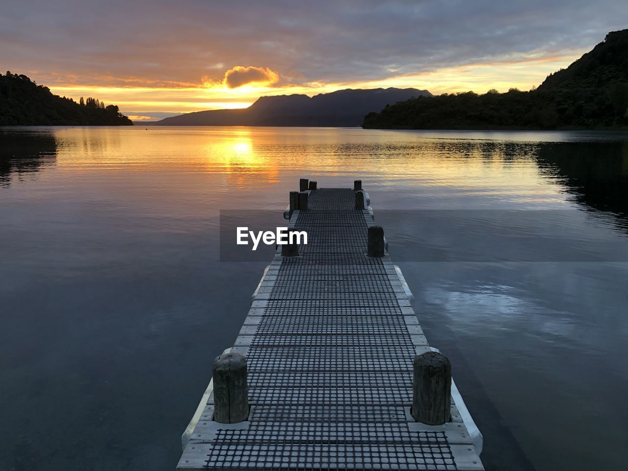 Scenic view of lake against orange sky, lake tarawera new zealand 