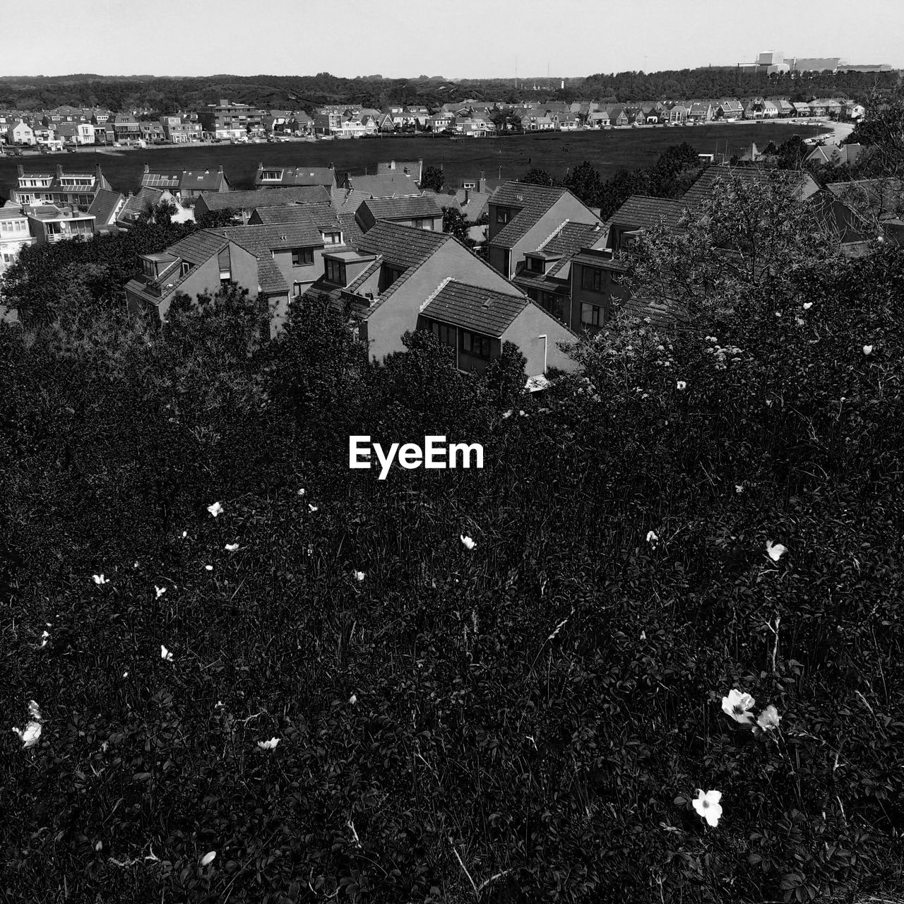 High angle view of houses in town against sky