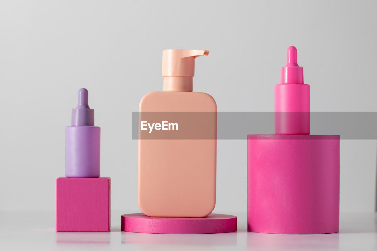 pink, magenta, bottle, container, studio shot, beauty product, no people, group of objects, indoors, violet, purple, lavender, cosmetics, make-up, nail polish, cut out, multi colored