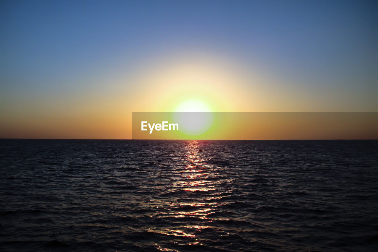 Scenic view of sea against clear sky during sunset