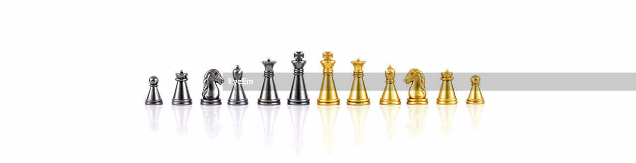 Close-up of chess pieces against white background