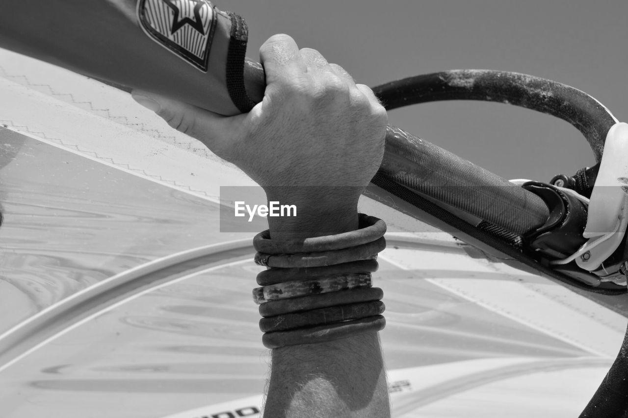 Cropped hand of man holding pole