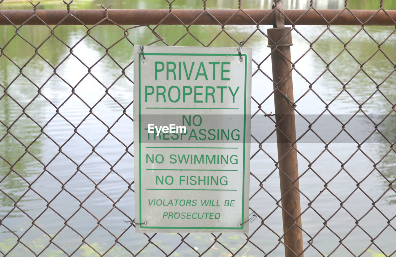 WARNING SIGN ON FENCE