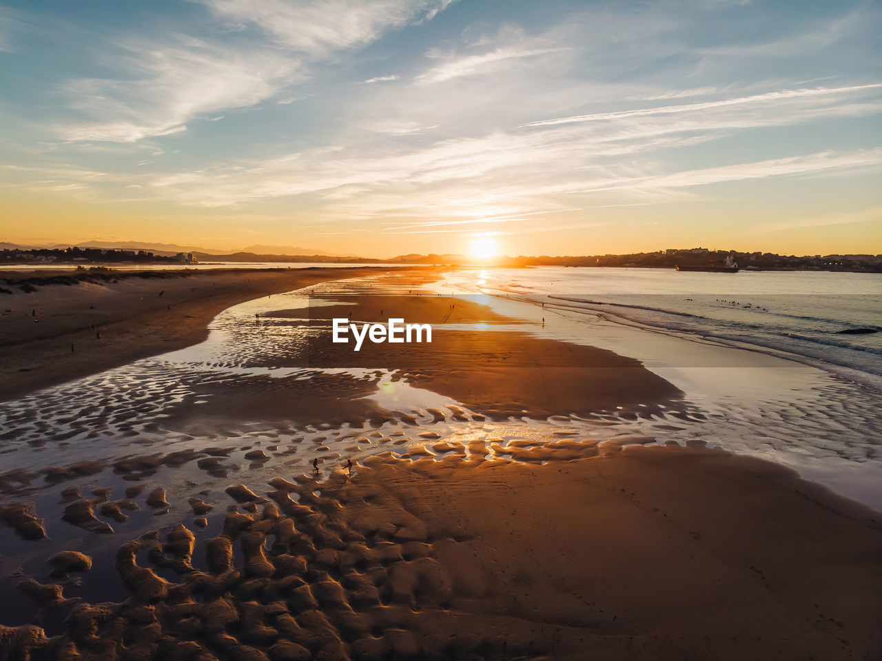 SCENIC VIEW OF BEACH AGAINST SKY AT SUNSET