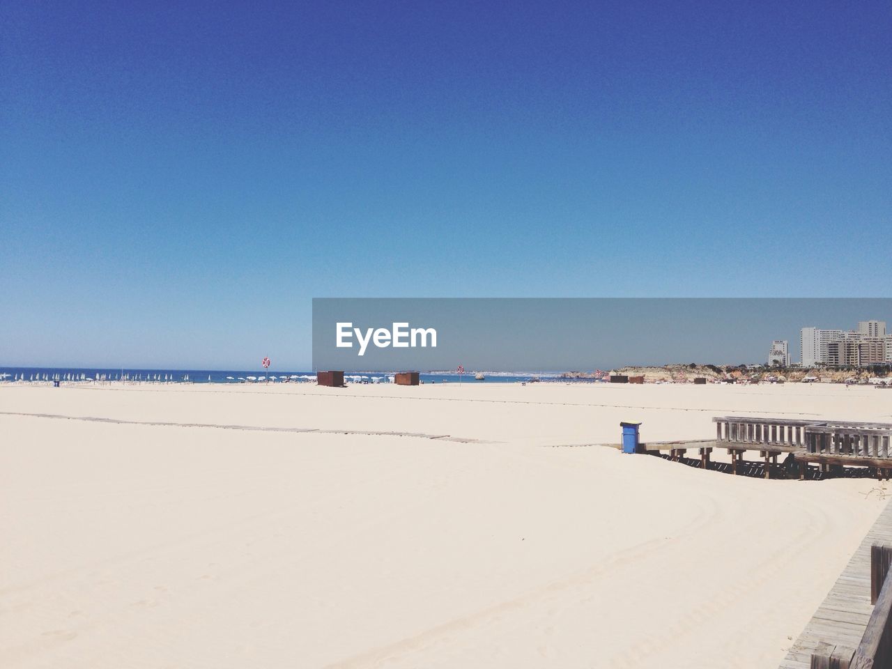 Scenic view of beach against clear blue sky at portimao