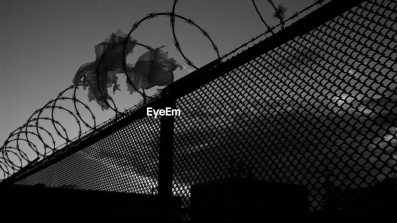 Low angle view of fence against clear sky