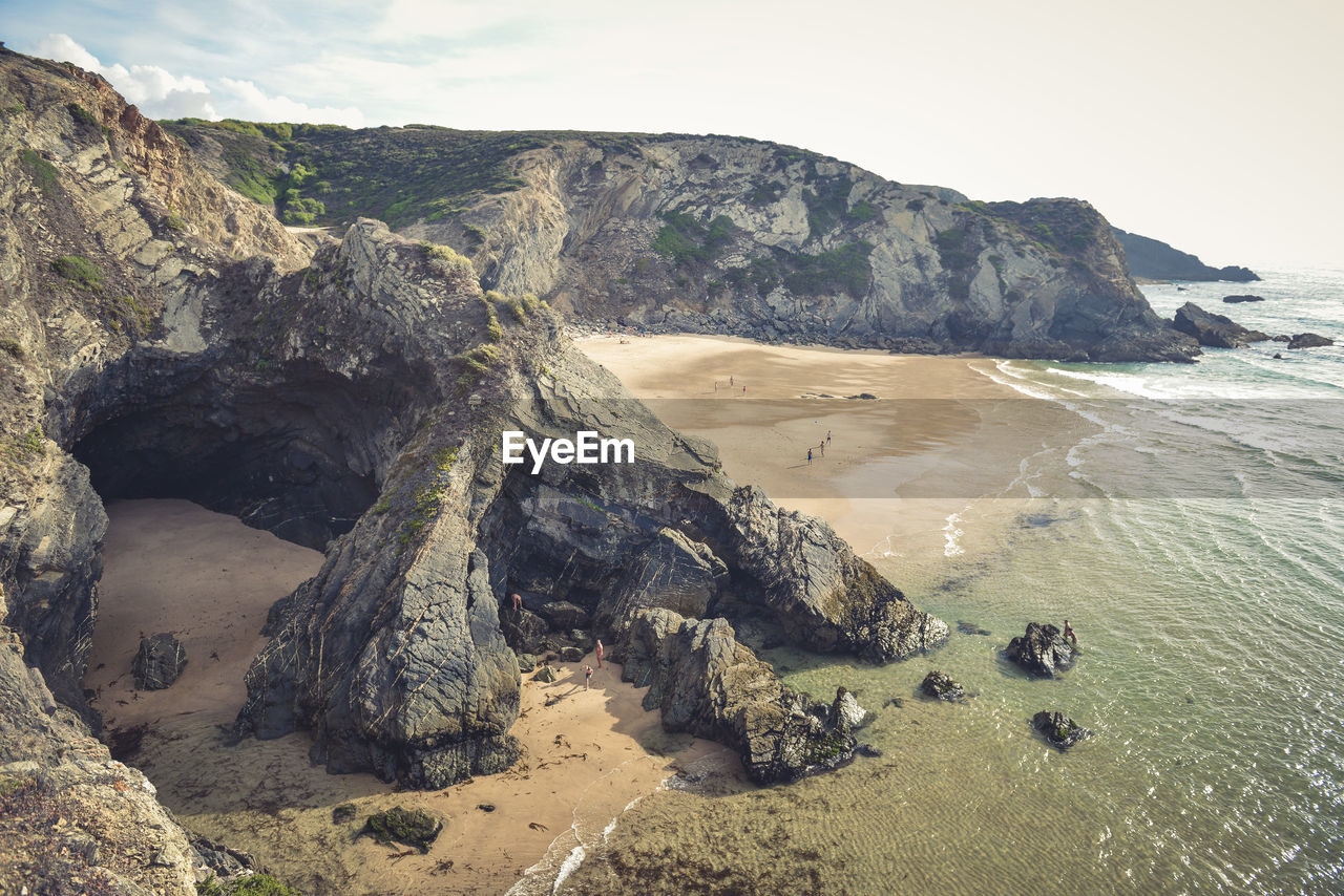 High angle view of rocks on beach against sky