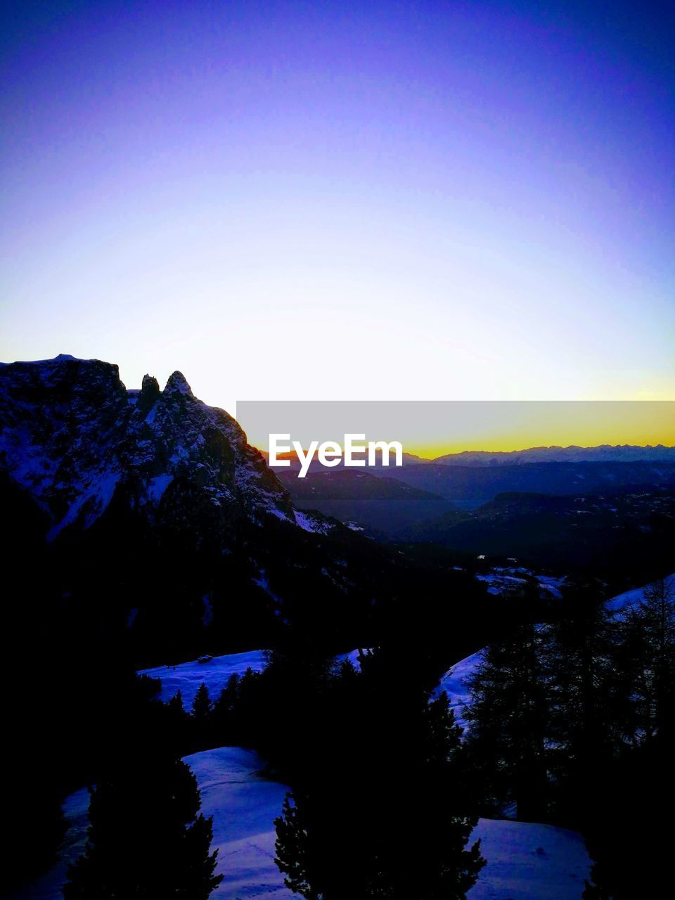 SCENIC VIEW OF MOUNTAINS AGAINST CLEAR SKY AT SUNSET