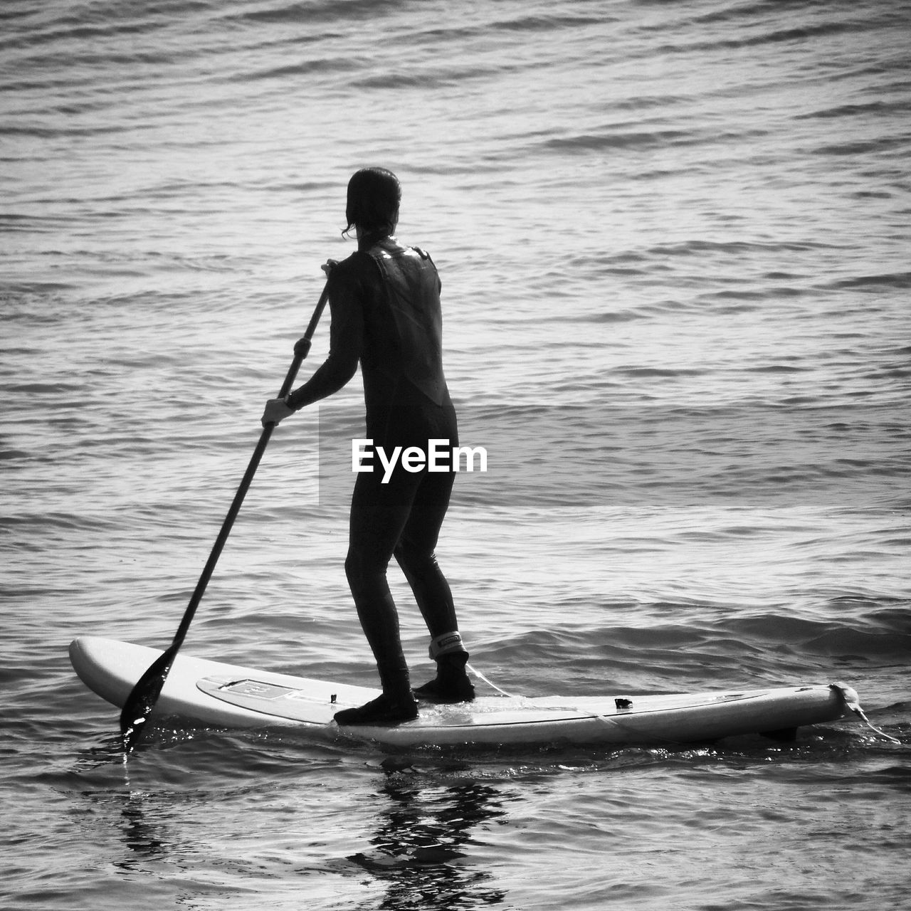 Full length of man paddleboarding in sea