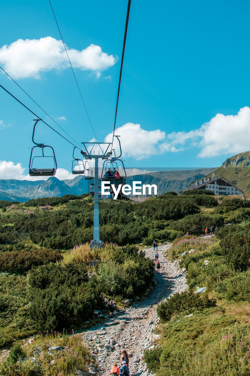 Low angle view of overhead cable car against sky