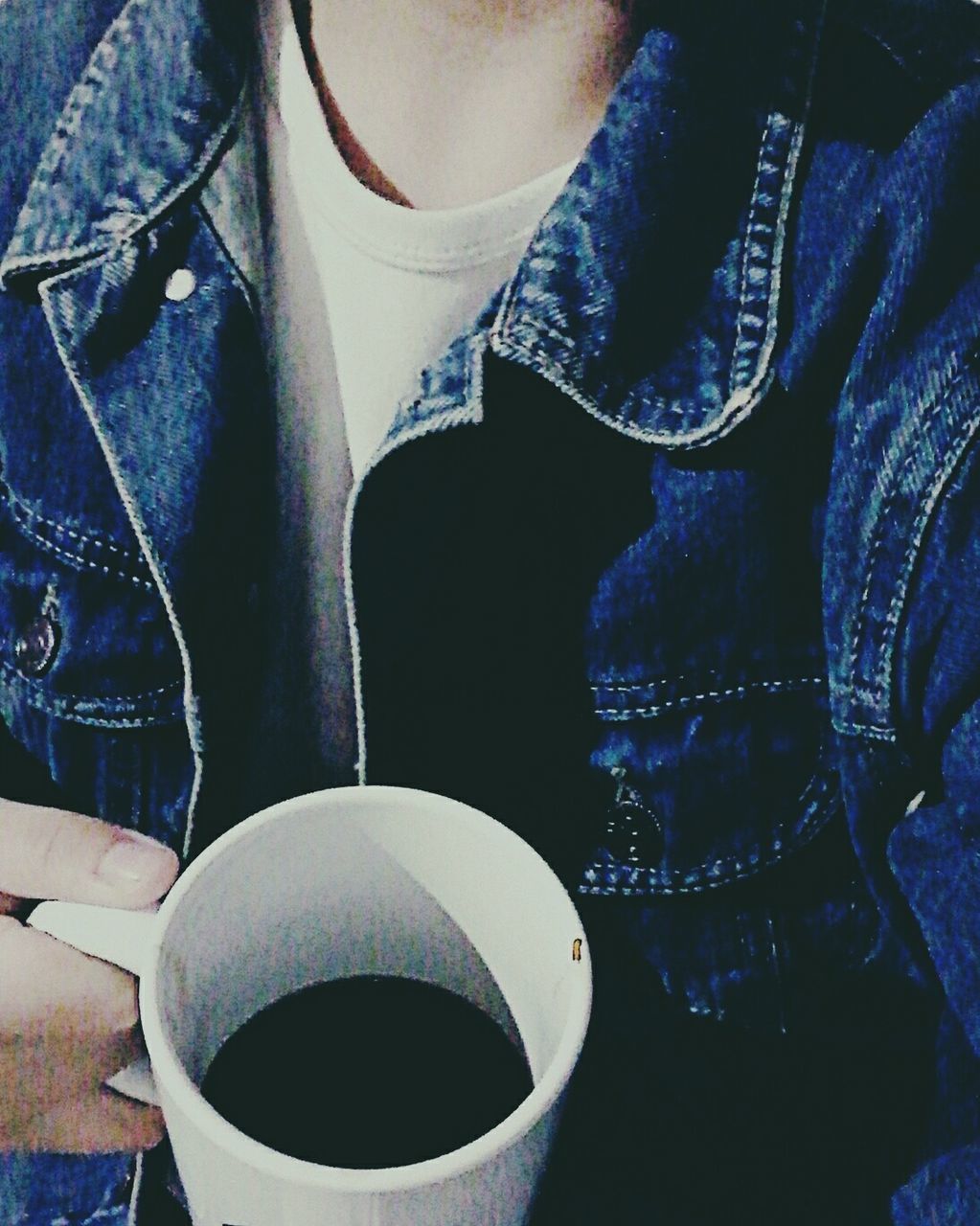 LOW SECTION OF PERSON WITH DRINK ON BLUE TABLE