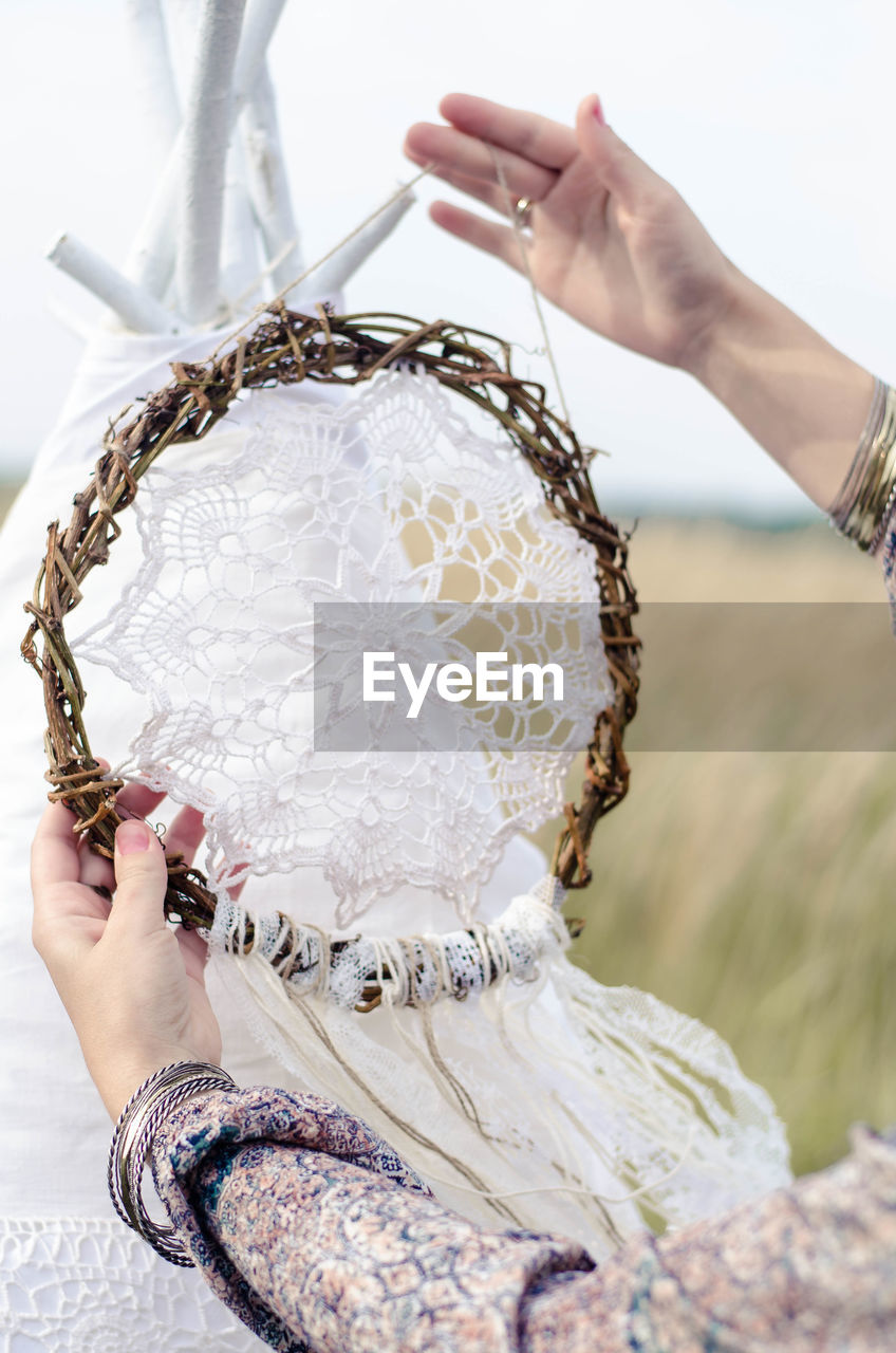 Cropped hands of woman holding decoration