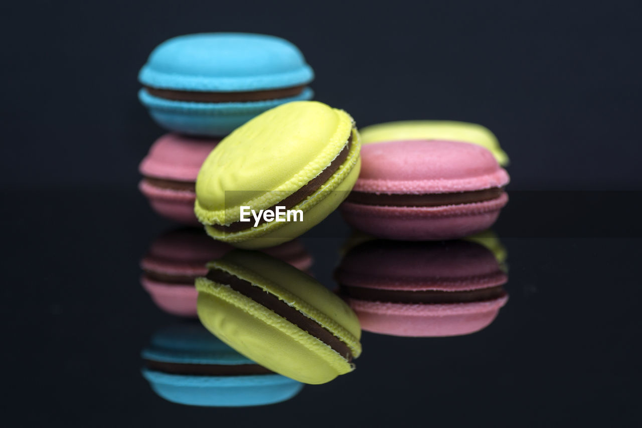 Close-up of multi colored macaroons over black background