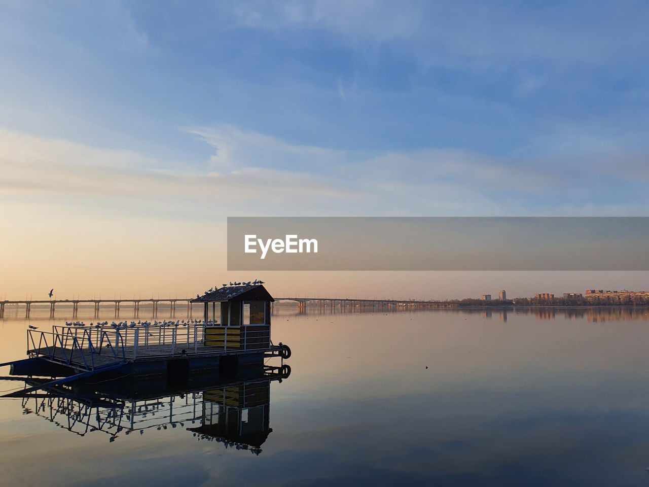 Avian wooden house over water.  view of the river before sunset