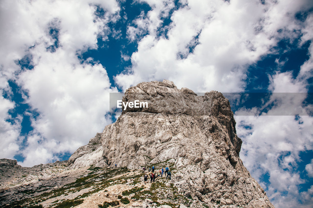 Low angle view of rocky mountain against sky