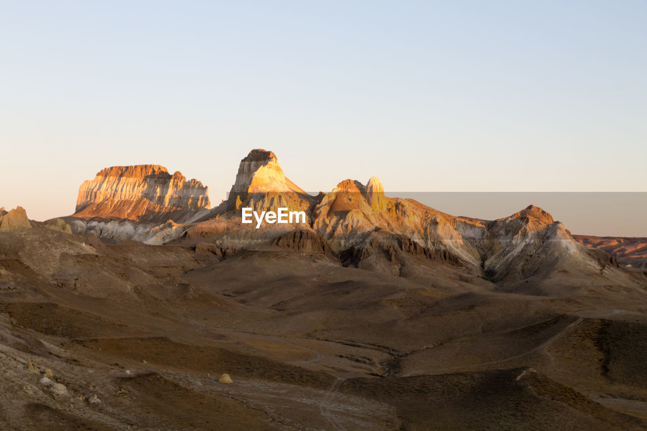 scenic view of mountains against clear sky during sunset