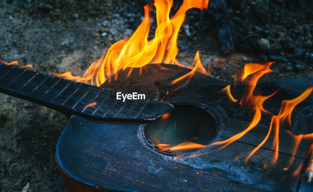 Shot of an acoustic guitar engulfed in strong flames