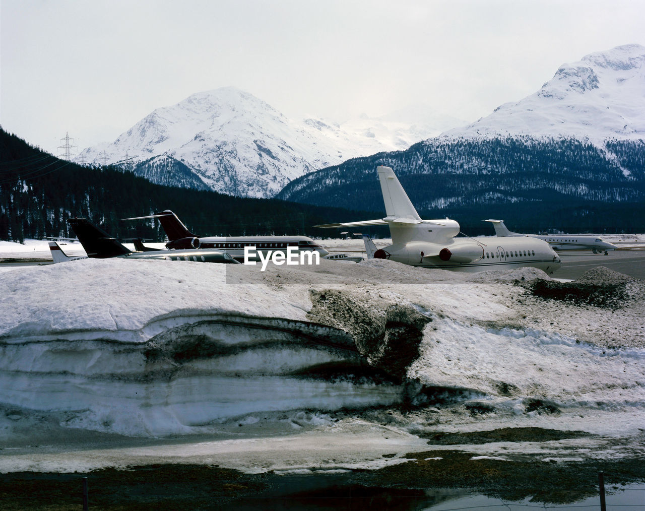 SCENIC VIEW OF FROZEN LAKE AGAINST SNOWCAPPED MOUNTAINS