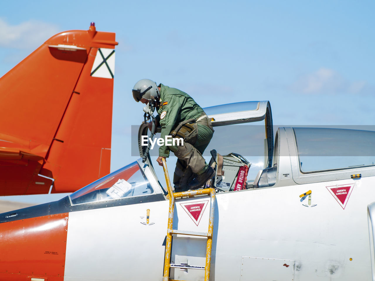 MAN ON AIRPLANE AT AIRPORT