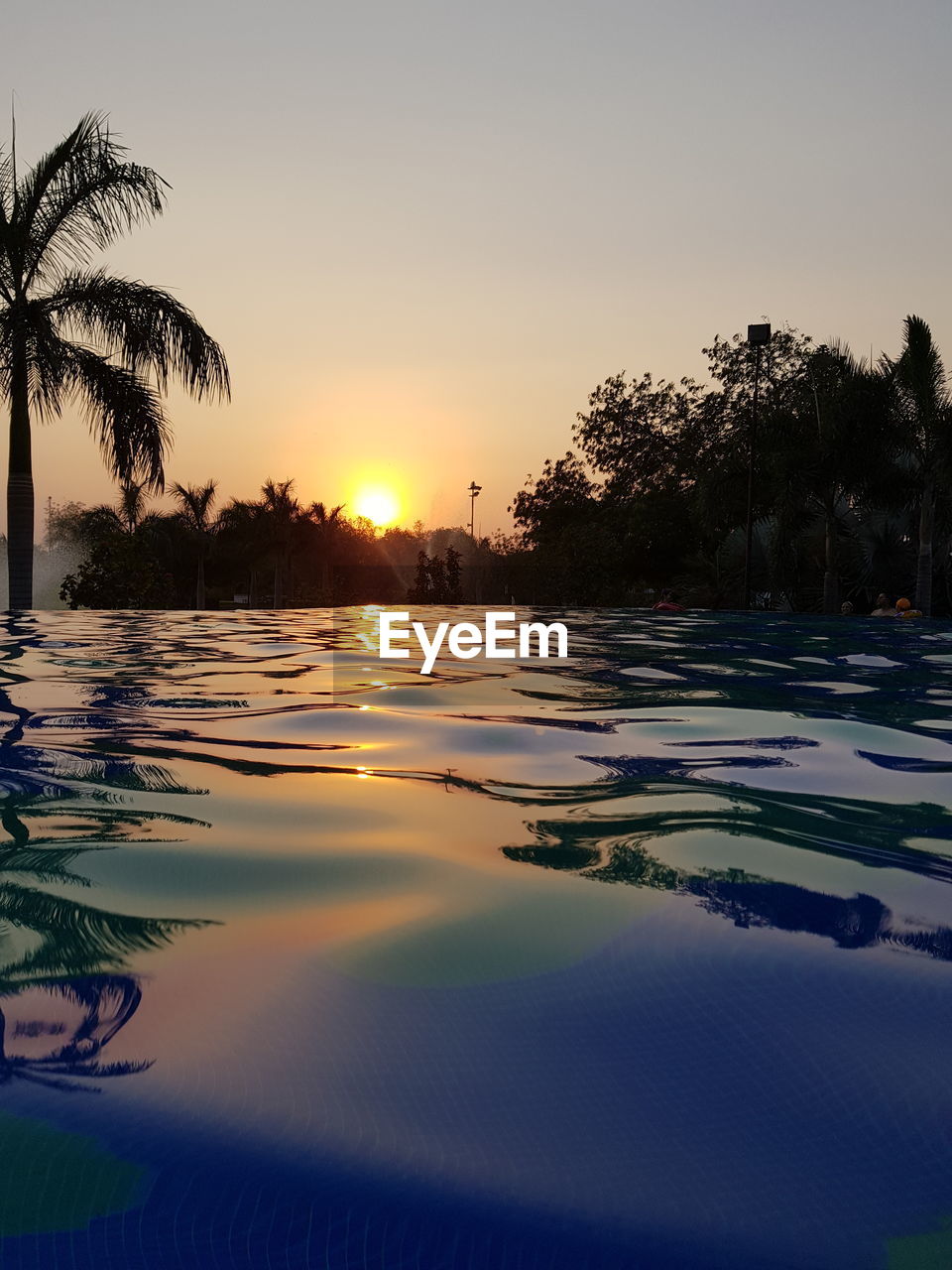VIEW OF SWIMMING POOL AT SUNSET