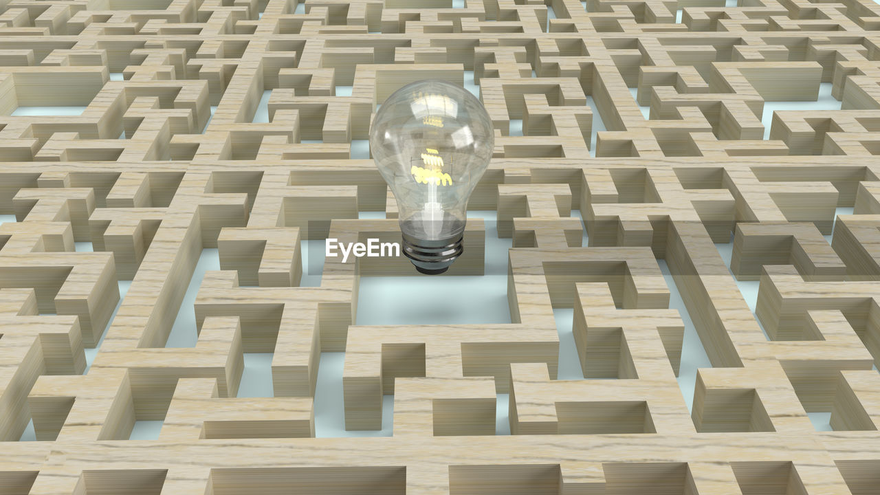 HIGH ANGLE VIEW OF ELECTRIC LIGHT BULB ON BRICK WALL