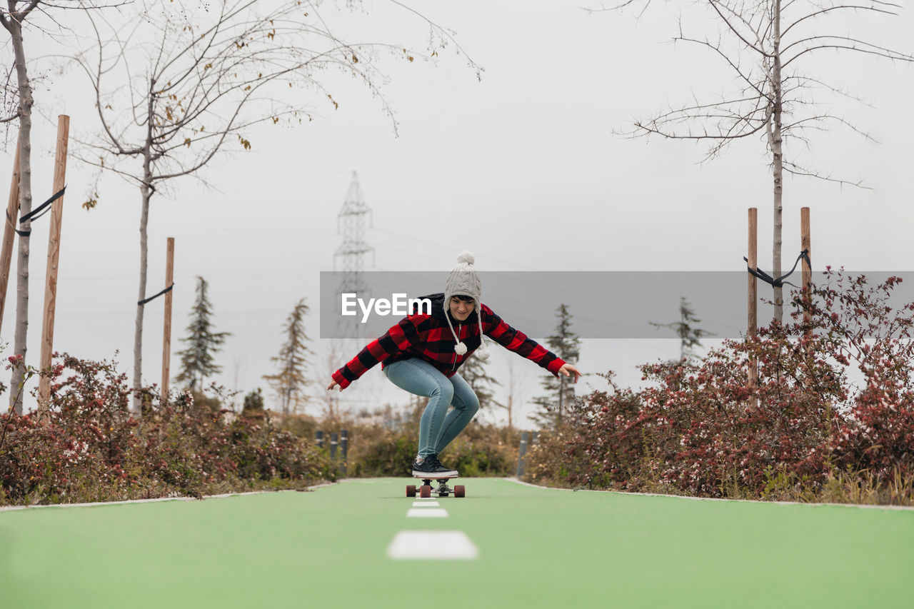 Young woman skateboarding outdoors